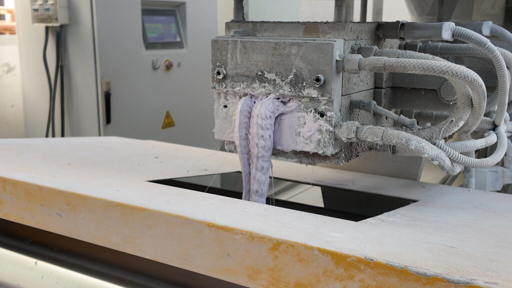 Close-up detail of powder coating extrusion and processing line