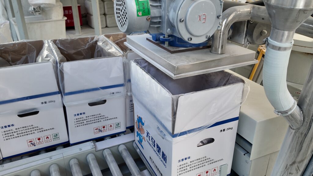 Close-up detail of powder coating extrusion and processing line